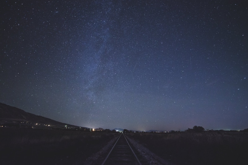 railroad, no people, sky, non-urban scene, galaxy, night, lights, the way forward, tranquil scene, vanishing point, star, beauty in nature, photo, silhouette