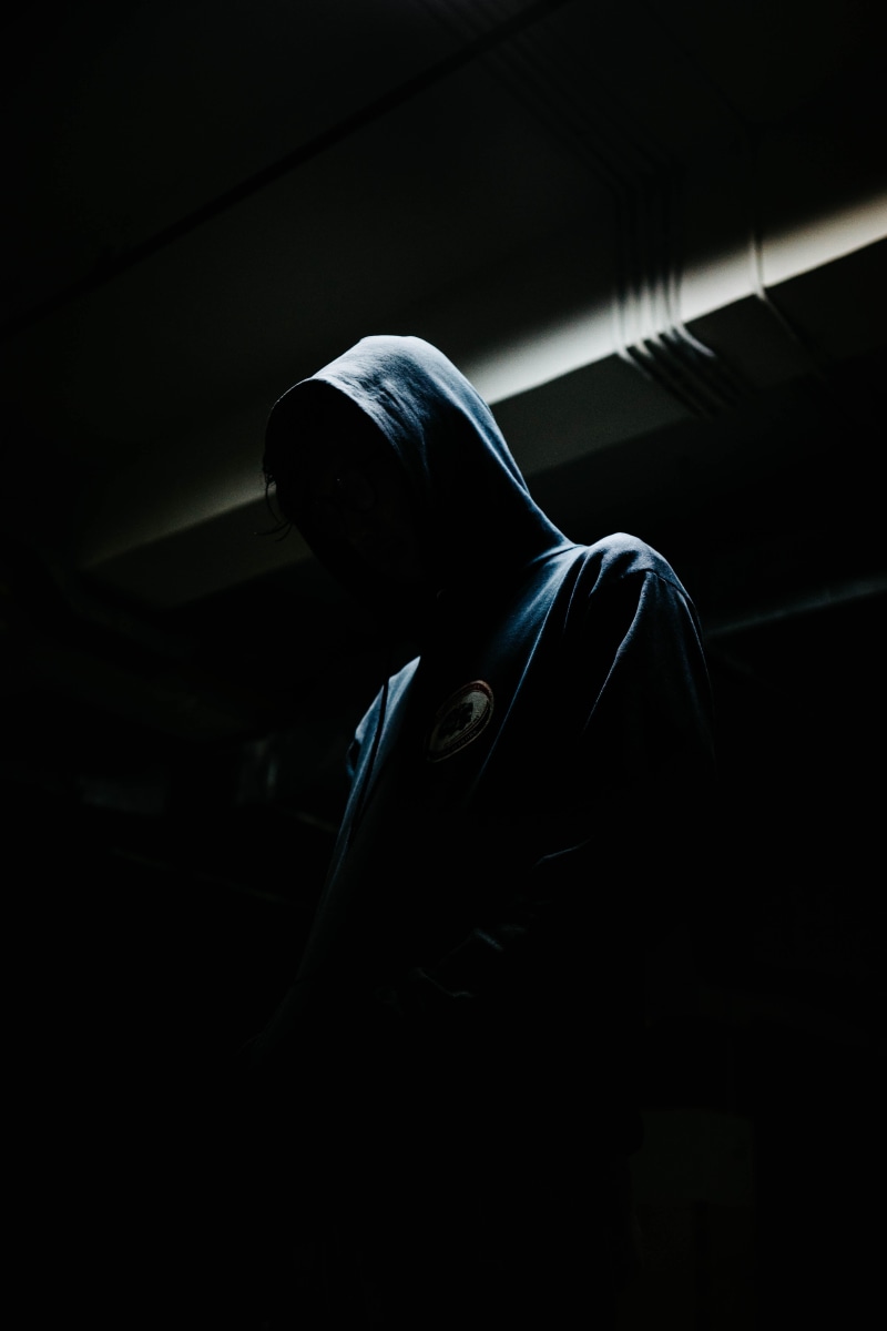 studio shot, person, side view, unrecognizable person, men, standing, motion, black background, indoors, night, hooded shirt, dark, male, one person, hood - clothing