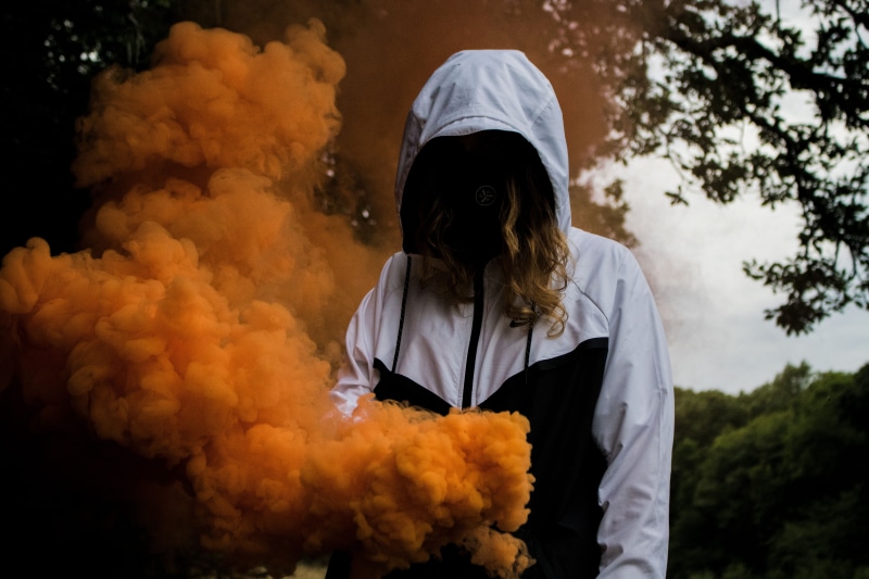 outdoors, near, white color, smokes, tree, hoodie, white, hype, foliage, black, wearing, hood, warning sign, person, obscured face, hood - clothing, fire