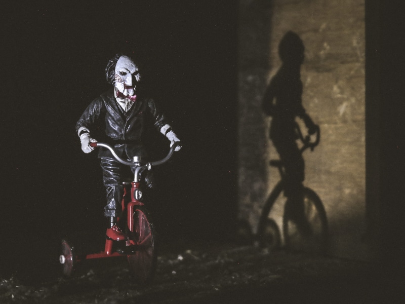 film, riding, saw, front view, 2K, helmet, puppet, play, bike, scary, extreme sports, motorcycle, tricycle, night, transportation, dark, mode of transportation