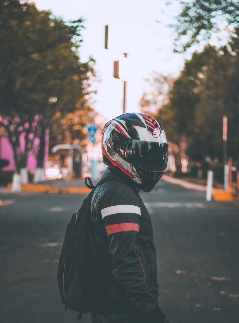 plant, child, face, street, city, outdoors, blur, full, men, motorcyclist, headwear, childhood, day, red, focus on foreground, nature, side view, standing