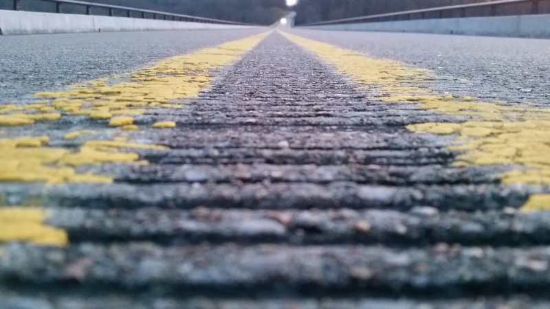 road marking, worms eye view, diminishing perspective, textured, 1080P, surface level, outdoors, area, black, day, sign, double yellow line, no people
