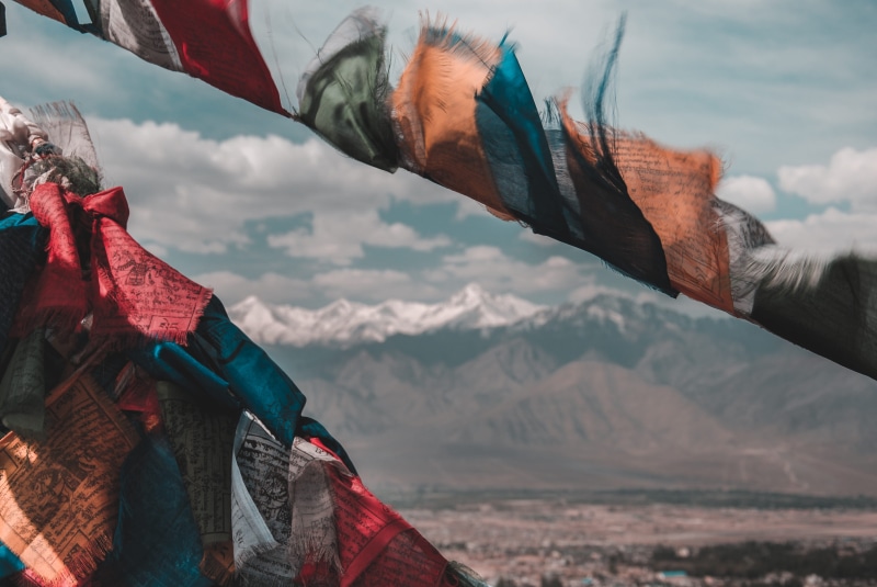moody, cloud - sky, tranquil scene, beauty in nature, views, outdoors, day, mood, snow, flag, sky, himalayas, belief, mountain, calm, spirituality, winter