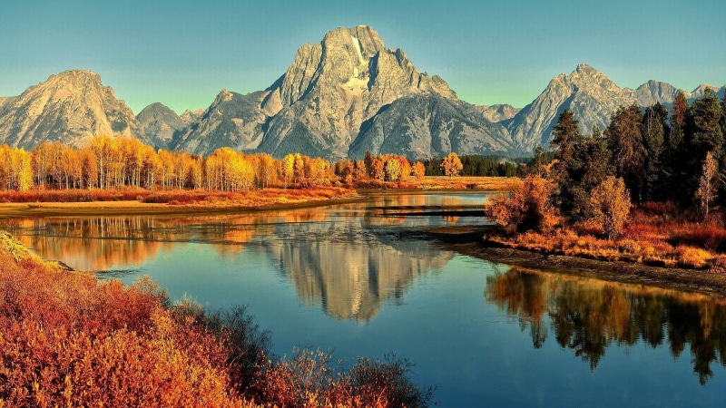 beauty in nature, tranquil scene, environment, mountain range, plant, water, reflection, sky, day, landscape, no people, tranquility, river, lake, mountains