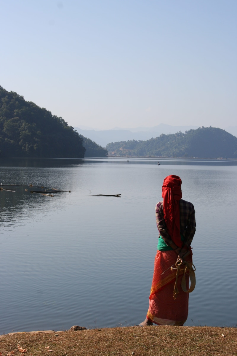 sitting, rear view, one person, leisure activity, nepal, clear sky, scenics - nature, nature, hills, sky, landscape, water, tranquil scene, full length