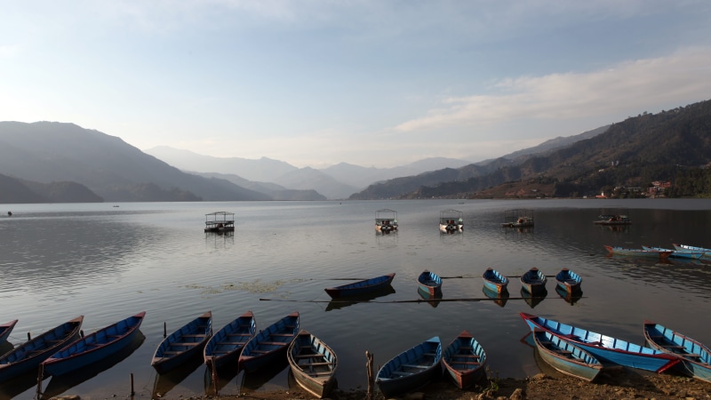 lake, mode of transportation, 5K, men, tranquility, cloud - sky, nautical vessel, mountain, real people, nature, moored, sky, nepal, non-urban scene, beauty in nature