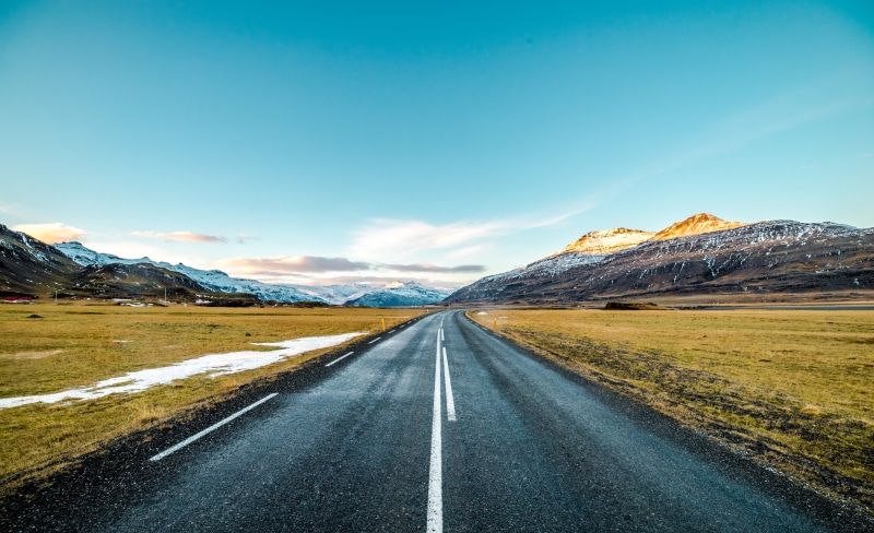 snow, symbol, landscape, sunlight, outdoors, diminishing perspective, road, mountains, sky, long, mountain, marking, transportation, no people, the way forward