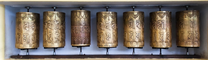business, religious, in a row, no people, handmade, antique, side by side, religious artifact, buddhist, metal, group of objects, communication, indoors