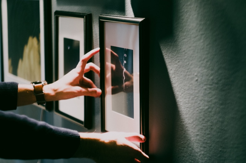 real people, decor, aligning, frame, hand, body part, human body part, indoors, picture, touching, finger, 5K, art, women, day, push button, framed, wall