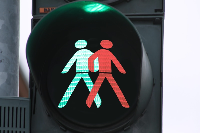 transportation, male likeness, counterproductive, road, lighting equipment, disagreement, outdoors, human representation, guidance, alignment, illuminated