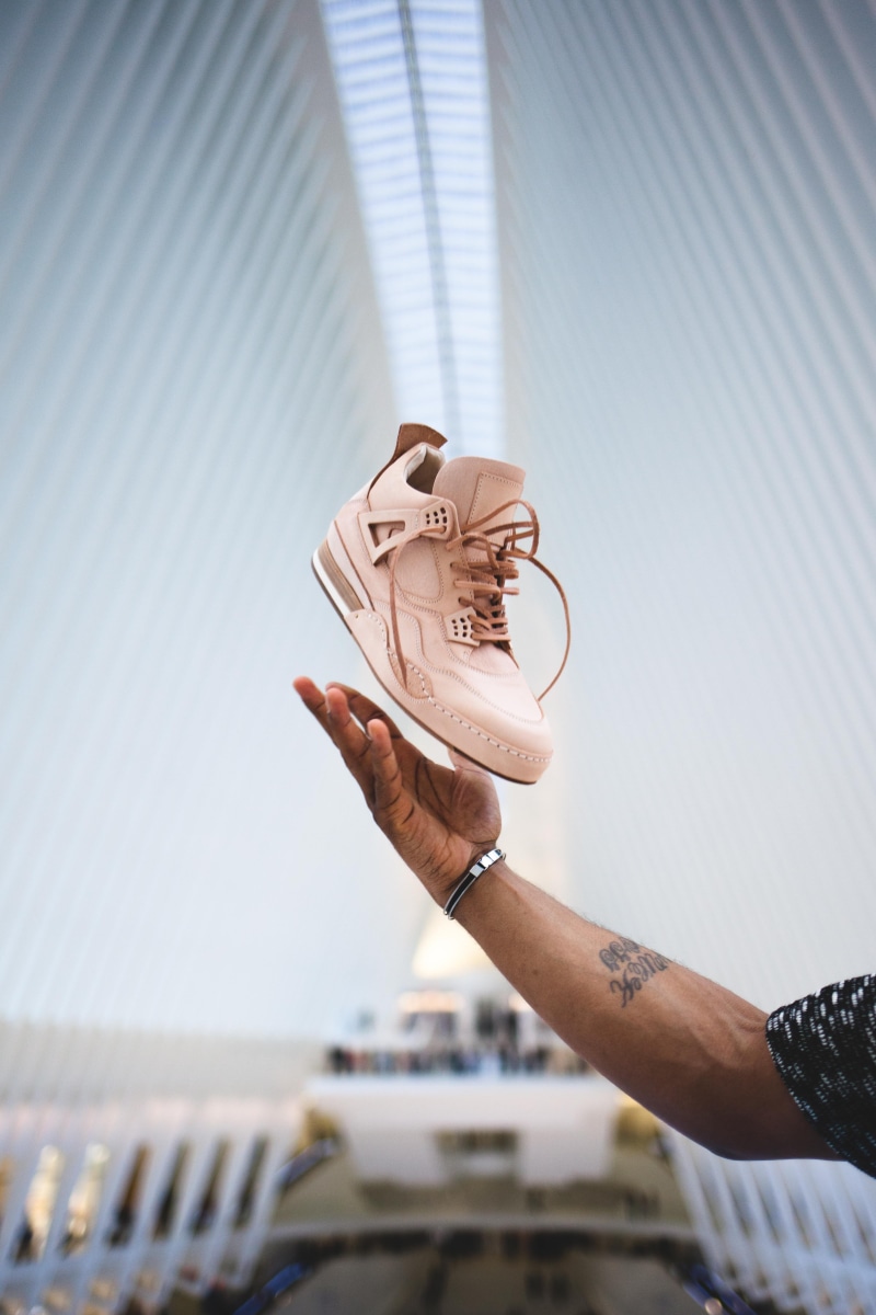 day, unpaired, holding, men, nyc, hand, jordan, shoe, sports, watch, unrecognizable person, product photo, modern shoe, finger, modern, human limb, focus on foreground