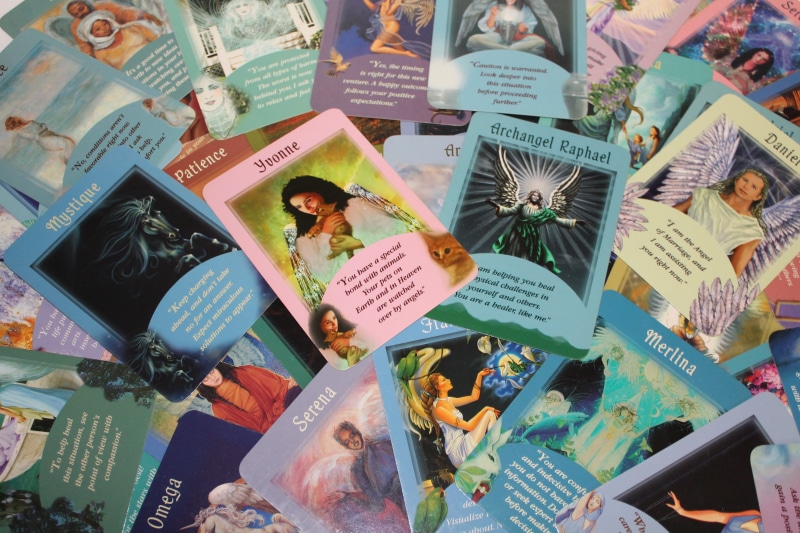 indoors, forecast, high angle view, backgrounds, male likeness, female likeness, table, representation, no people, angel cards, cards, human representation