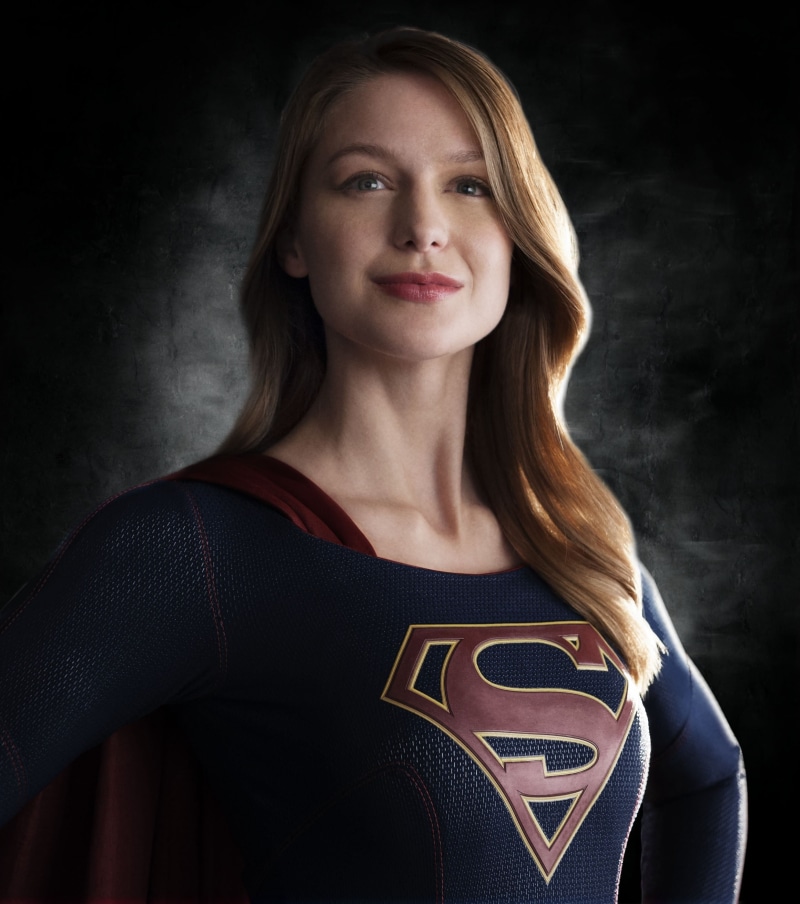 looking at camera, blond hair, black background, Supergirl, super, headshot, mid adult women, women, girl, emotion, smiling, 2K, one person, mid adult