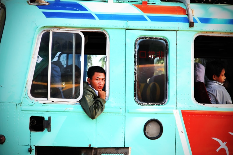 service bus, land vehicle, outdoors, transportation, incidental people, day, bus, glass - material, sitting, window, train, public transportation, mode of transportation