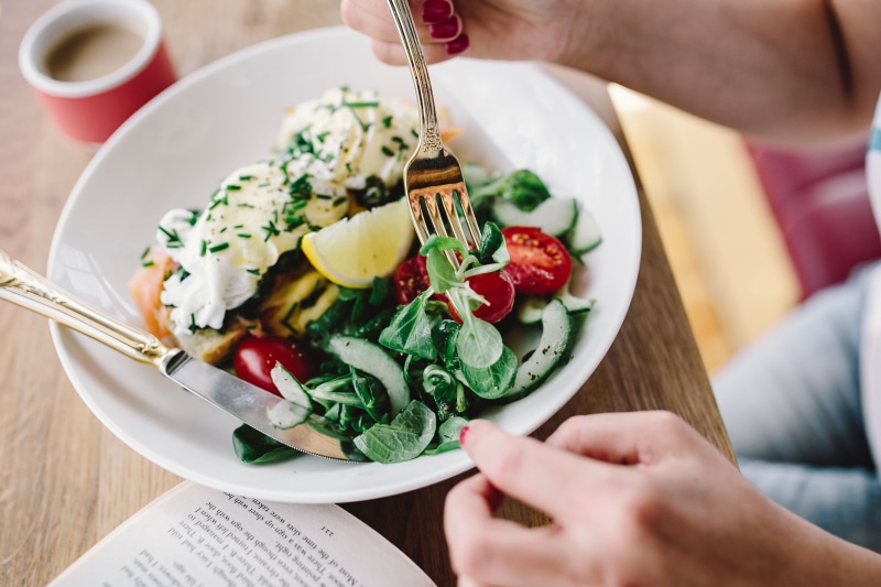 eating utensil, plate, only women, reading, color Image, indoors, meal, book, table, Woman, close-up, healthy, food, women, hand, one woman only, breakfast