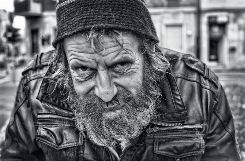 facial hair, focus on foreground, one person, wrinkled face, zip, 1080P, jacket, real people, outdoors, headshot, old people, leather, males, social issues