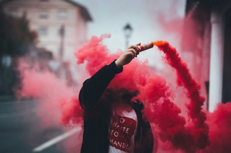 cloudy, canister, human limb, waist up, man, urban, focus on foreground, limb, pink color, lifestyles, cover, architecture, shirt, arms raised, one person