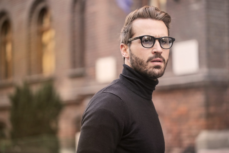one person, bearded, fashion, travel, posing, specs, focus on foreground, top, male, young men, young, men, city, eyeglasses, street, black sweater, architecture