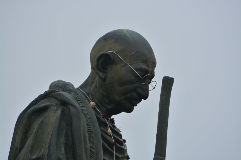 sky, outdoors, landmark, leader, human representation, young adult, art and craft, gandi, low angle view, famous, clothing, statue, site, 5K, gandhi, listening