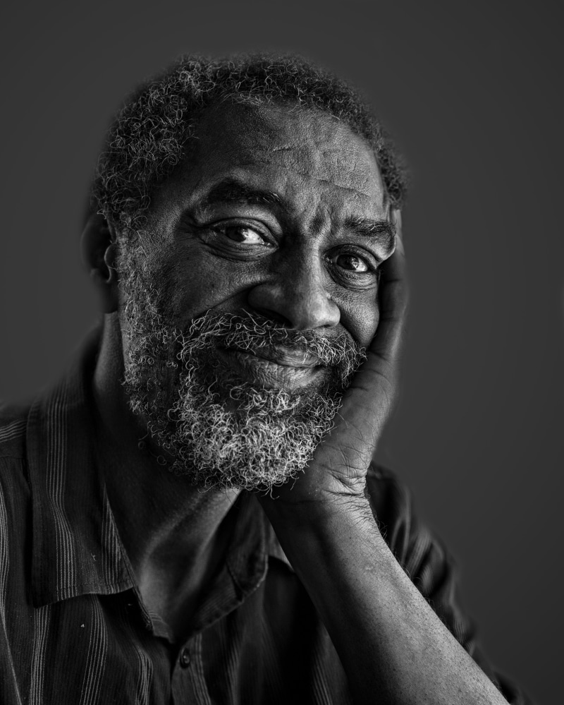 studio shot, smiling, lifestyles, human face, mature men, cheerful, Portrait, indoors, looking at camera, grayscale, People, one man only, close-up, adults only
