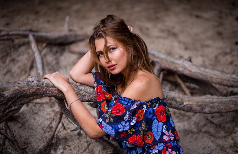 leisure activity, outdoors, lifestyles, auburn hair, bare shoulders, looking at viewer, adult, women outdoors, rock - object, rock, focus on foreground
