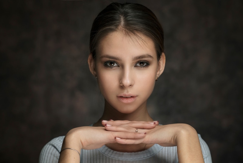 hairstyle, looking at camera, beautiful woman, one person, hands clasped, nose rings, 1080P, studio shot, adult, front view, face, human body part, young adult