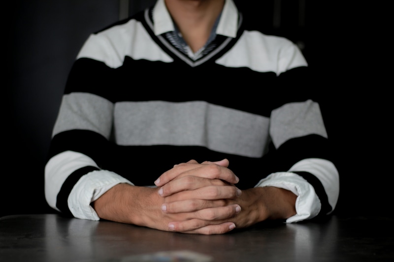 royalty  images, black-and-white, close-up, spirituality, casual clothing, wearing, hand, man, business, black background, person, 5K, adult, hands clasped