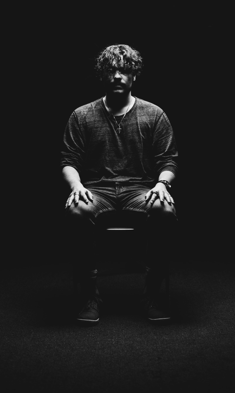 leisure activity, lifestyles, full length, dark, indoors, man, one person, chair, contemplation, hands clasped, photo, sitting, real people, front view