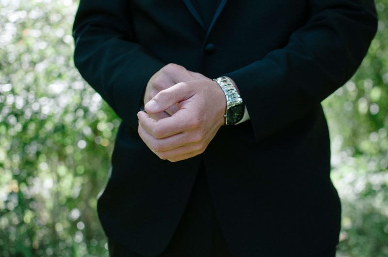 focus on foreground, men, ring, human body part, human limb, one person, grass, hands clasped, man, outdoors, waiting, adult, front view, close-up, standing