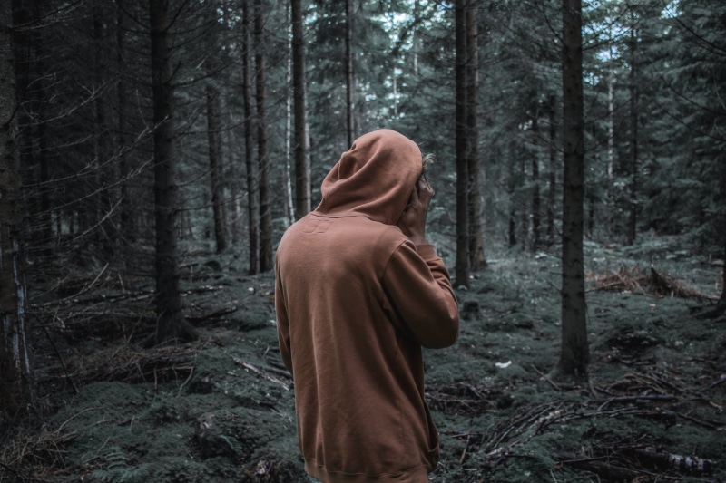problems, caucasian Ethnicity, standing, lifestyles, looking, grief, sullen, real people, hood, clothing, forest, tree, outdoors, danger, rear view, young Adult