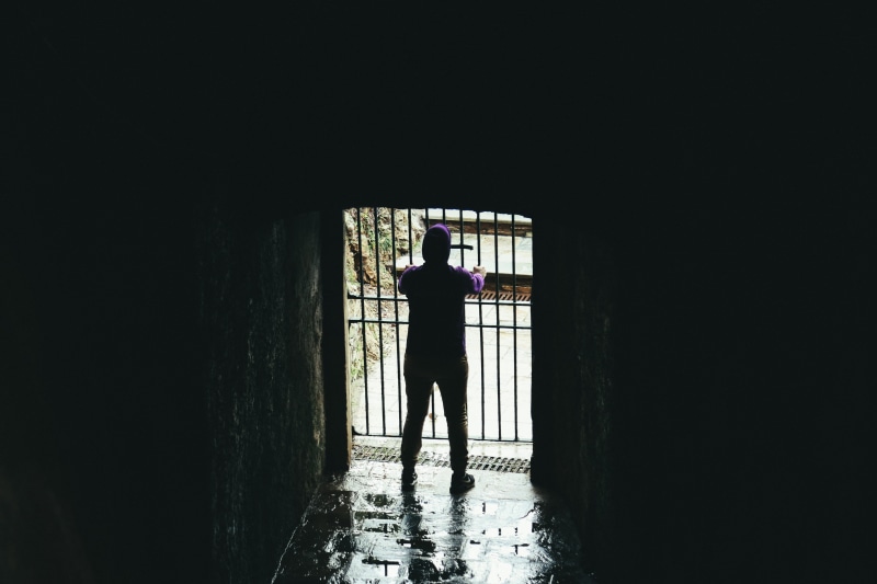 standing, indoors, tunnel, lifestyles, building, prison, architecture, light at the end of the tunnel, one person, silhouette, men, built structure, entrance