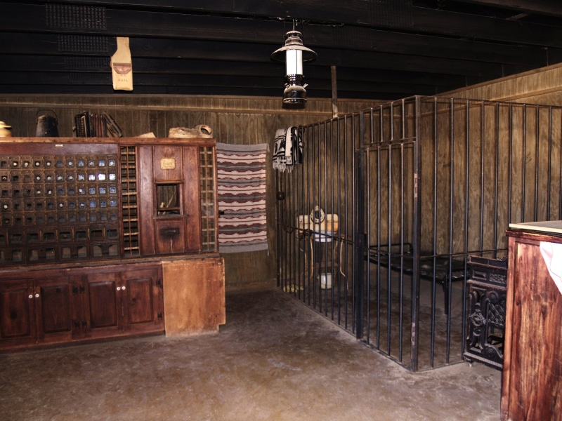 the past, beside, sheriff, antique, lighting equipment, cabinet, electric lamp, bars, wood - material, jail, no people, bar - drink establishment, wooden