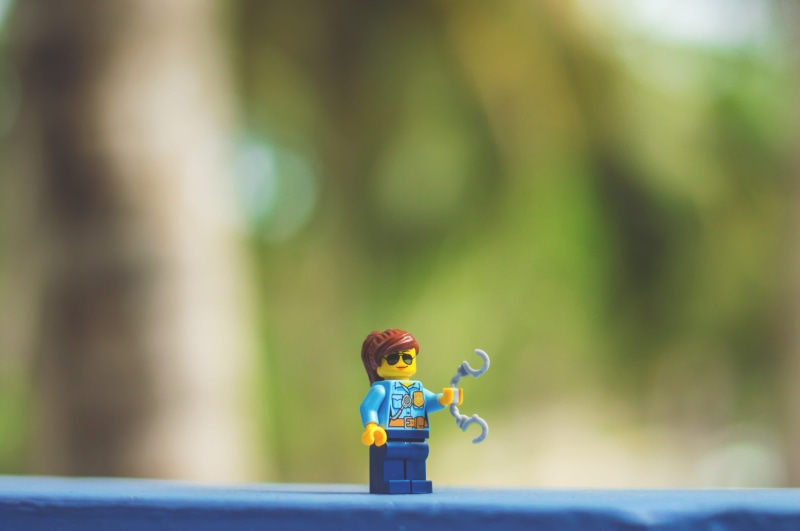 toy, art and craft, beauty, lego love, focus on foreground, cool, outdoors, hand cuffs, figurine, nature, selective focus, bird, jail, male likeness, handcuffs