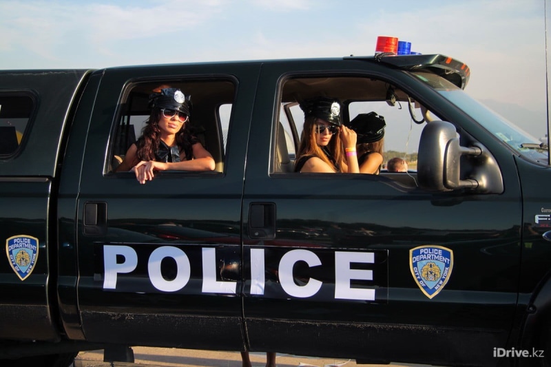 480P, police, vehicle, sitting, outdoors, people, real people, men, sunglasses, motor vehicle, communication, adult, model, car, black, land vehicle, group of people
