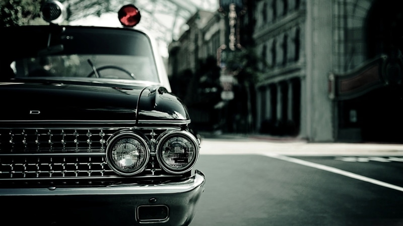 built structure, architecture, focus on foreground, glass - material, black, headlight, luxury, road, outdoors, no people, photography, police, vintage