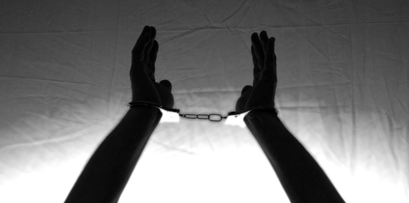 handcuffs, human leg, finger, standing, one person, in chains, slammer, women, lifestyles, caught, human hand, victims, arrest, leisure activity, liability