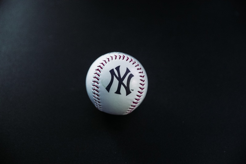 studio shot, text, black, positive emotion, surface, sphere, yankees, still life, baseball - ball, 5K, single object, pottery, white, porcelain, art, baseball