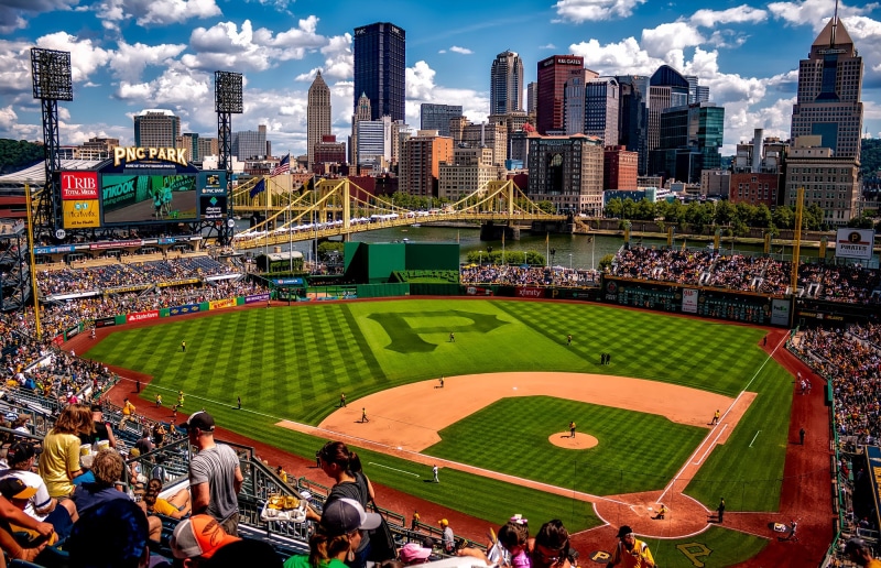 ballpark, outdoors, athletics, large group of people, fans, pirates, competition, office building exterior, city, crown, river, building, crowded, skyscraper