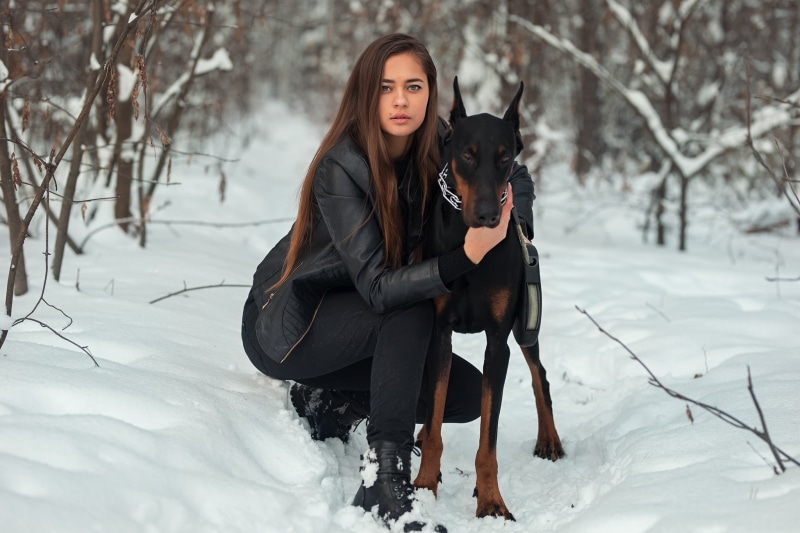 black jackets, 1080P, blue eyes, kneeling, snow, long hair, pet, brunette, animals, Dmitry Sn, black clothing, dog, outdoors, women outdoors, jacket, boots