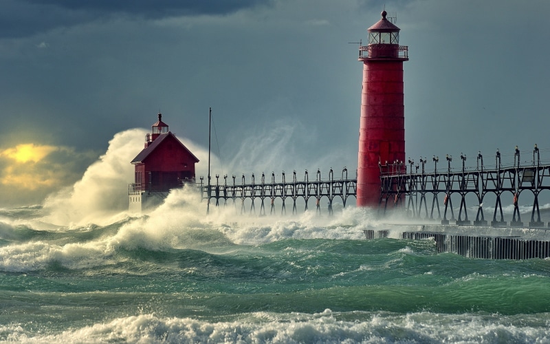 waterfront, guidance, architecture, sea, nature, power, building exterior, power in nature, water, built structure, wave, lighthouse, storm, motion, red