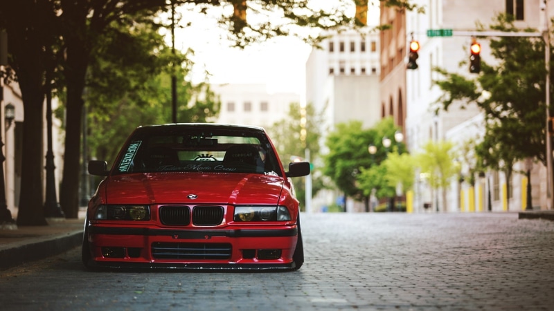 mode of transportation, road, land vehicle, tree, street, day, red, transportation, outdoors, plant, motor vehicle, tuning, 1080P, built structure, focus on foreground