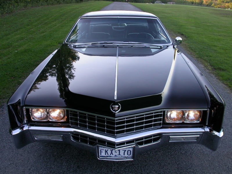 outdoors, 480P, motor vehicle, grass, day, black, nature, metal, high angle view, plant, asphalt, transportation, gray, vintage car, mode of transportation