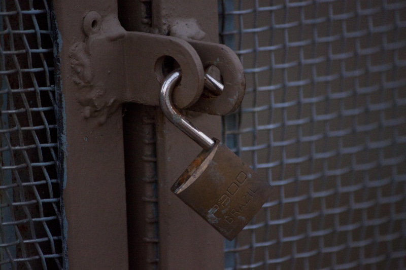 key, padlock, hasp, safety, brick, brick wall, fence, safekeeping, gate, lock, close-up, privacy, forbidden, outdoors, rusty, entrance, no people, protection