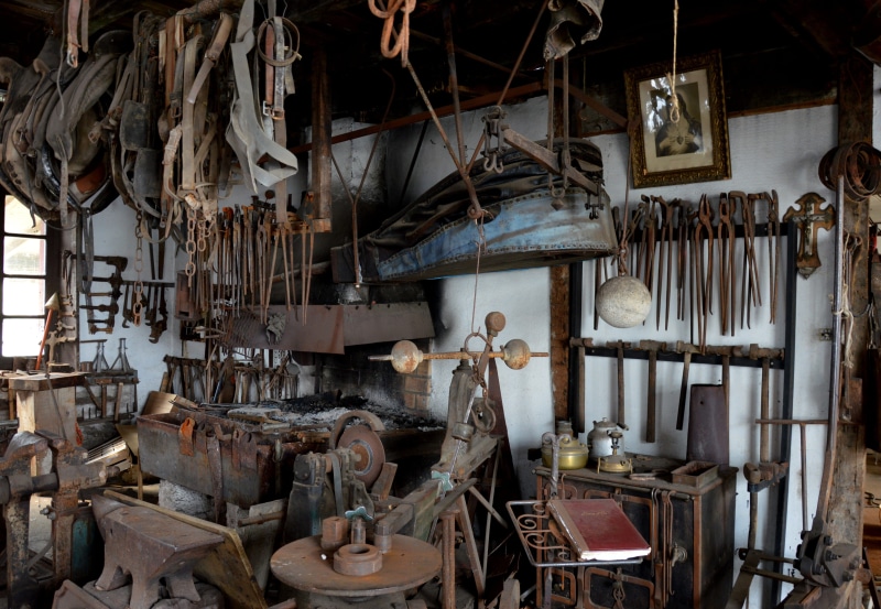 workshop, hanging, wrought iron, no people, day, variation, anvil, indoors, the past, history, forge, work tool, industry, choice, abundance, obsolete