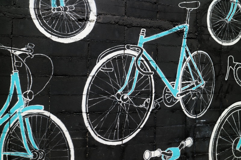 sport, wheel, wall - building feature, land vehicle, white, outdoors, spoke, tire, day, street, parking, black background, mode of transportation, city