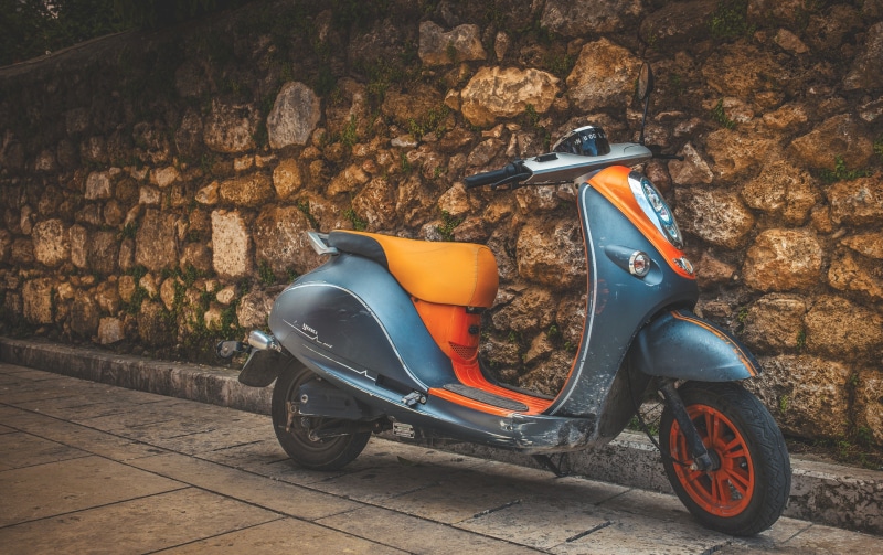 holiday, wall - building feature, motorcycle, land vehicle, street, motor scooter, orange color, 2K, travel, stone wall, mode of transportation, headlight