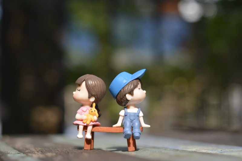 blurred background, portrait, child, love, boy, people, human representation, outdoors, girl, figurine, togetherness, sitting, little, males, leisure, toy