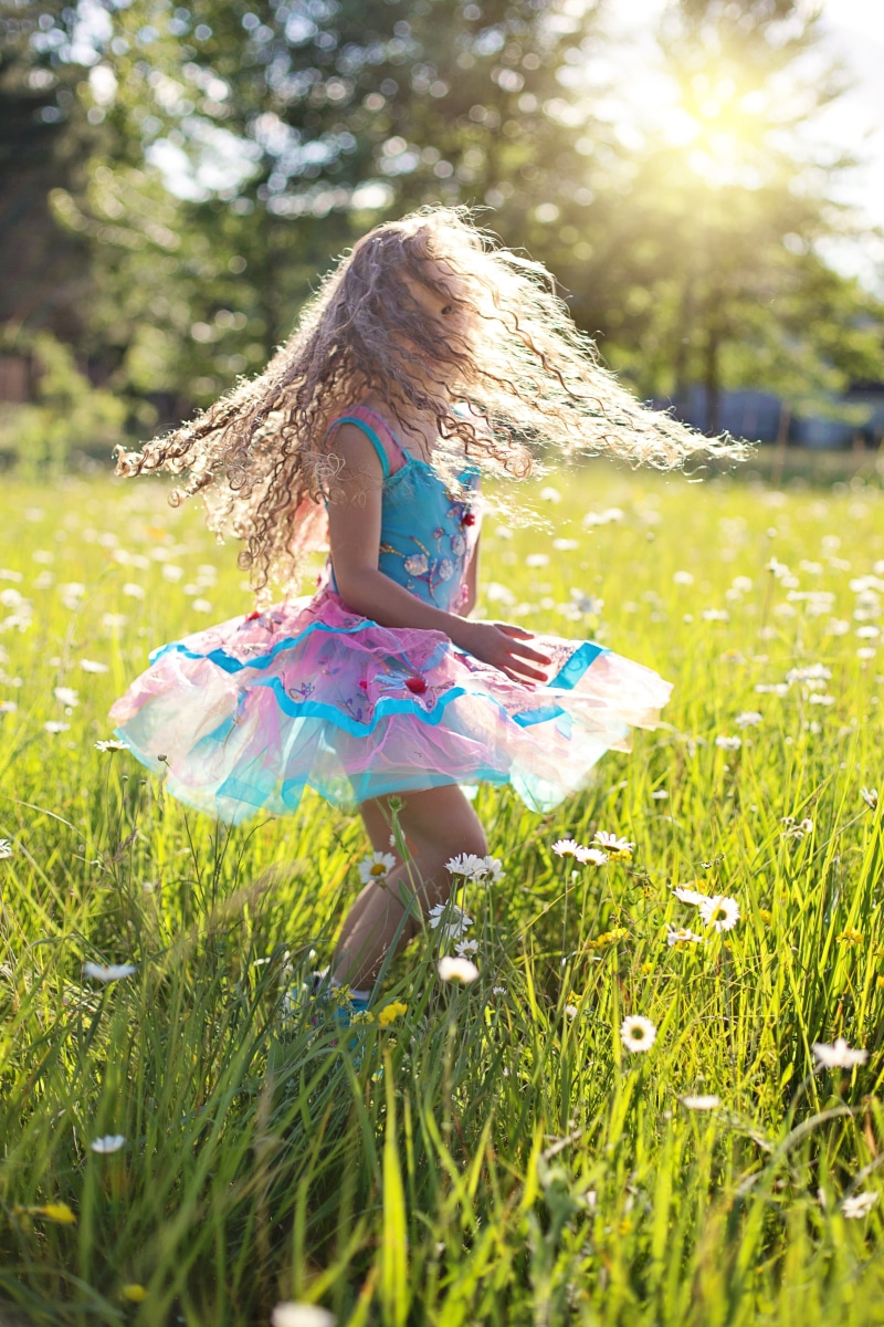 dance, twirling, real people, summer, hairstyle, outdoors, happy, little girl, lifestyles, nature, one person, childhood, innocence, dress, girl, kid, cute