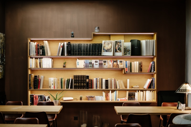 arrangement, furniture, bookshelf, book, seat, layer, wooden, publication, brown, desk, large group of objects, order, abundance, 5K, library, chair, indoors