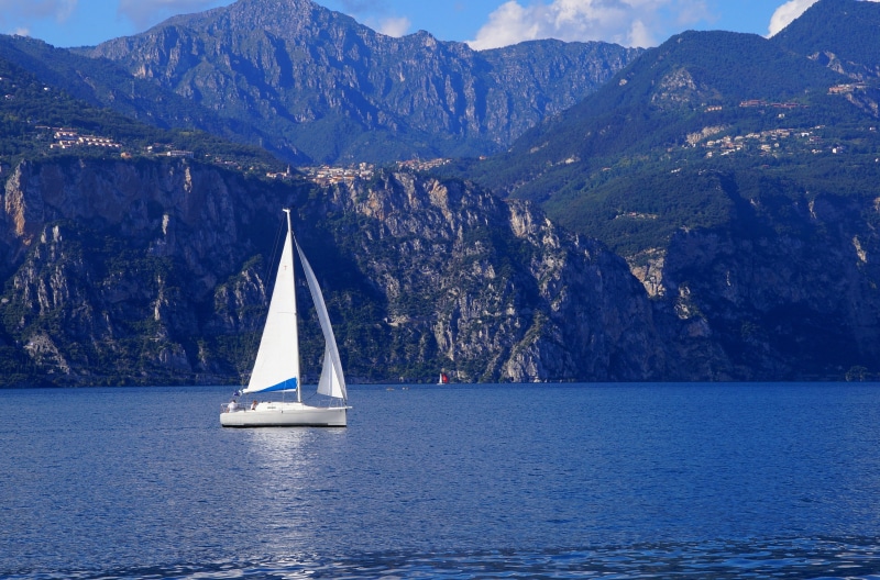 mode of transportation, white, mountain range, sail, beauty in nature, yachting, blue, outdoors, sea, cliff, yacht, italy, landscape, waterfront, scenics - nature